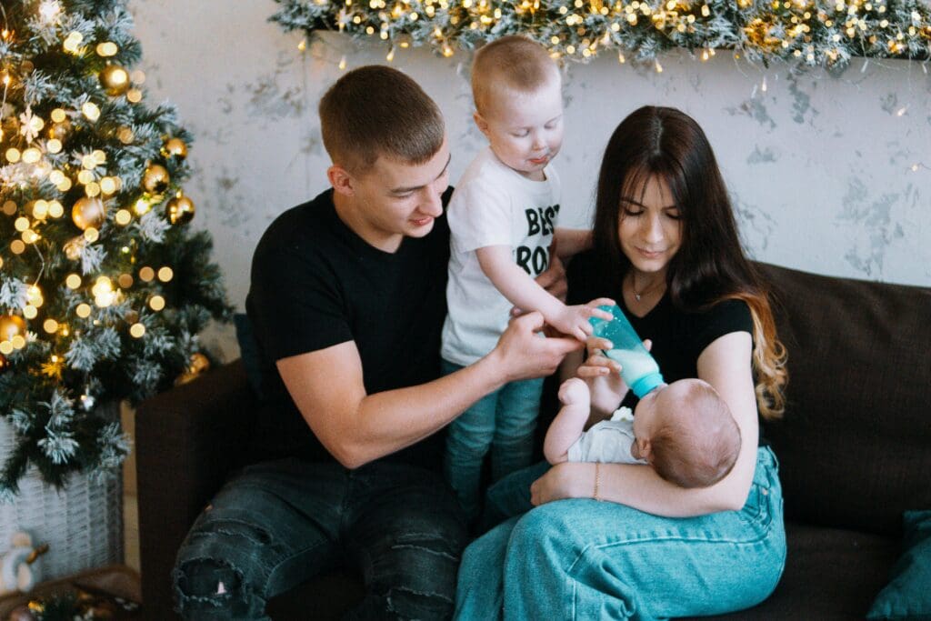 Family feeding a new baby with baby formula mixed with FreshPure Reverse Osmosis or Deionized Water.